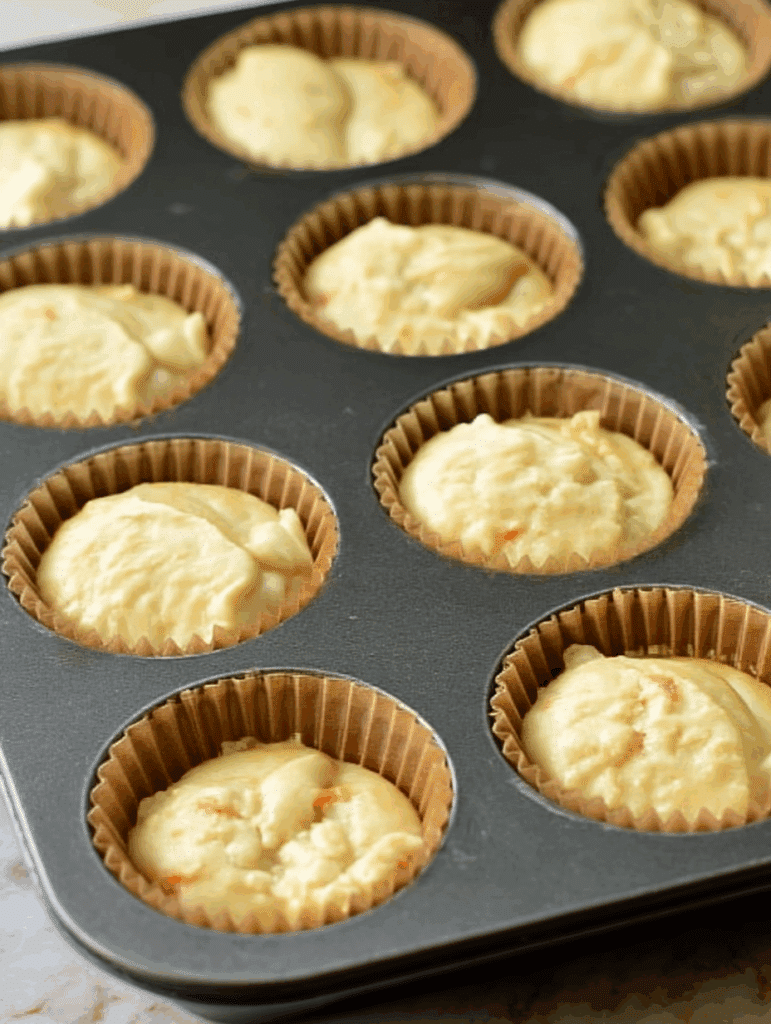 Scooping dairy-free muffin batter into pan
